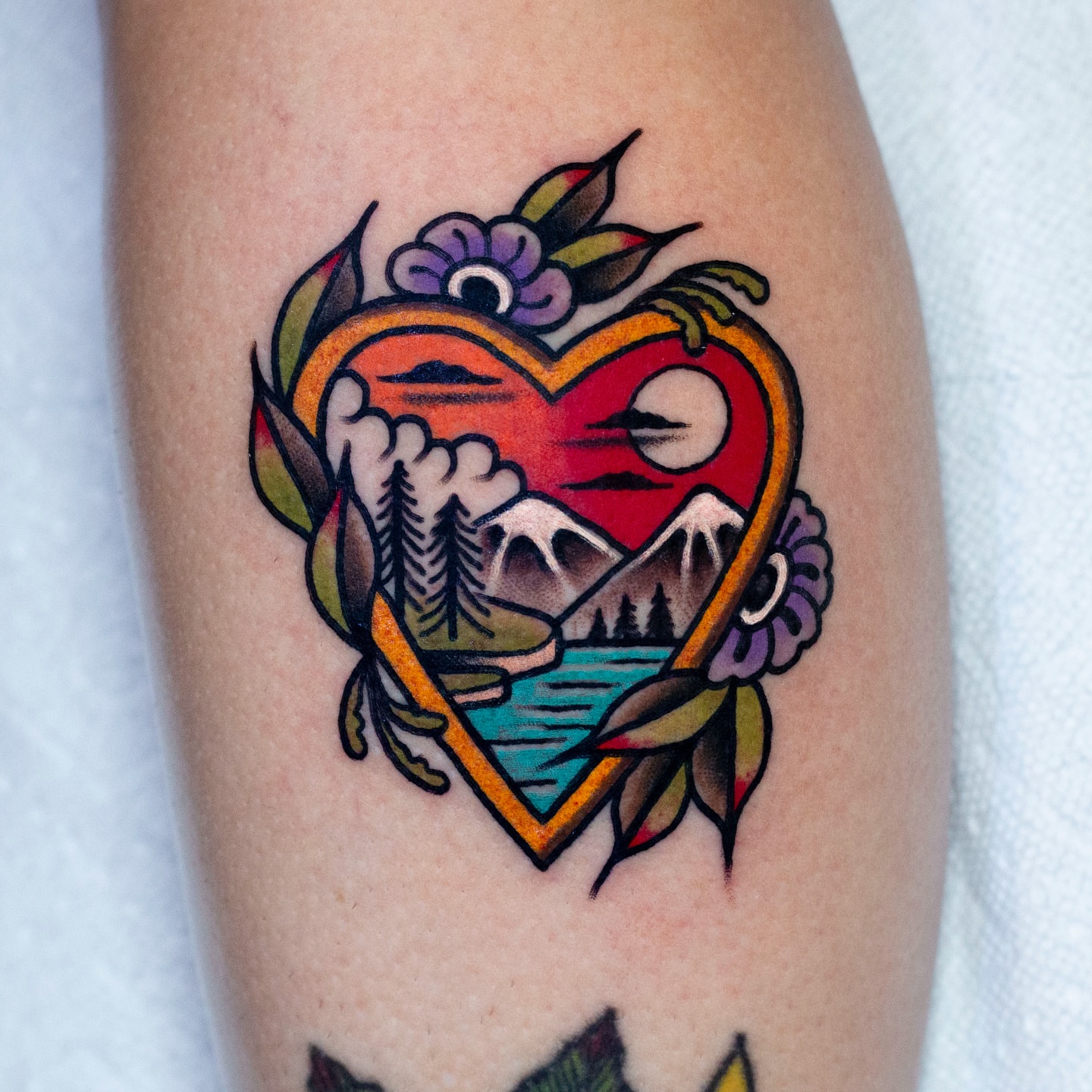 Heart landscape American traditional tattoo on the thigh by Miguel Comin