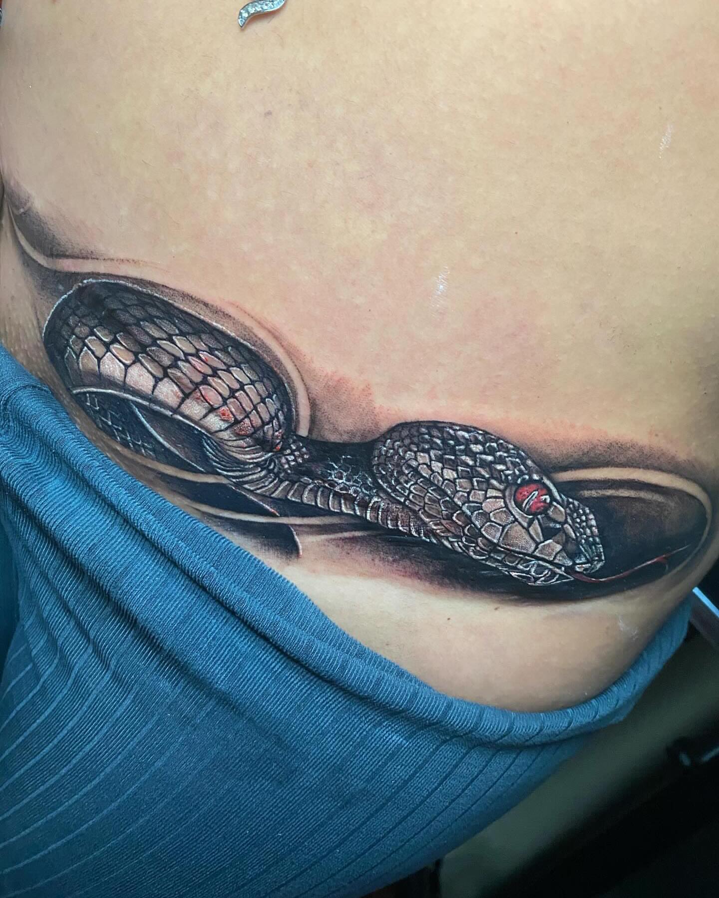 Snake realism tattoo on the chest by Juan Lira