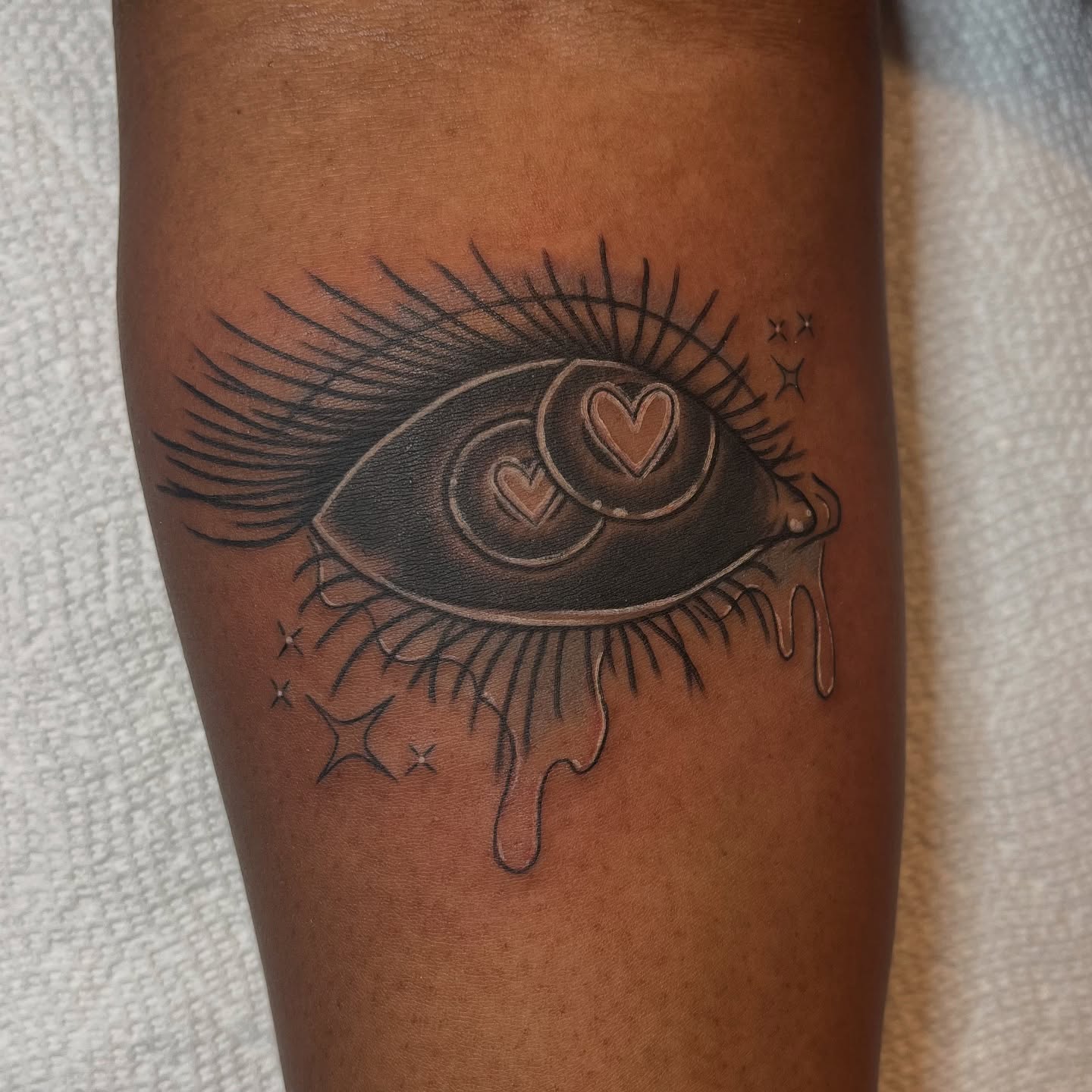 Eye with hearts realism tattoo on the forearm by Krystal ✨