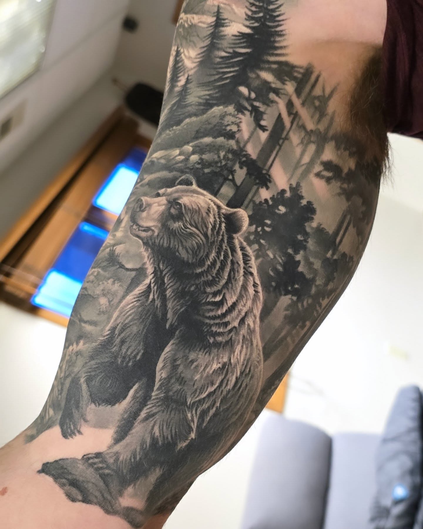 Bear in forest realism tattoo on the forearm by Alexander L. Wolff, Rapid City, South Dakota