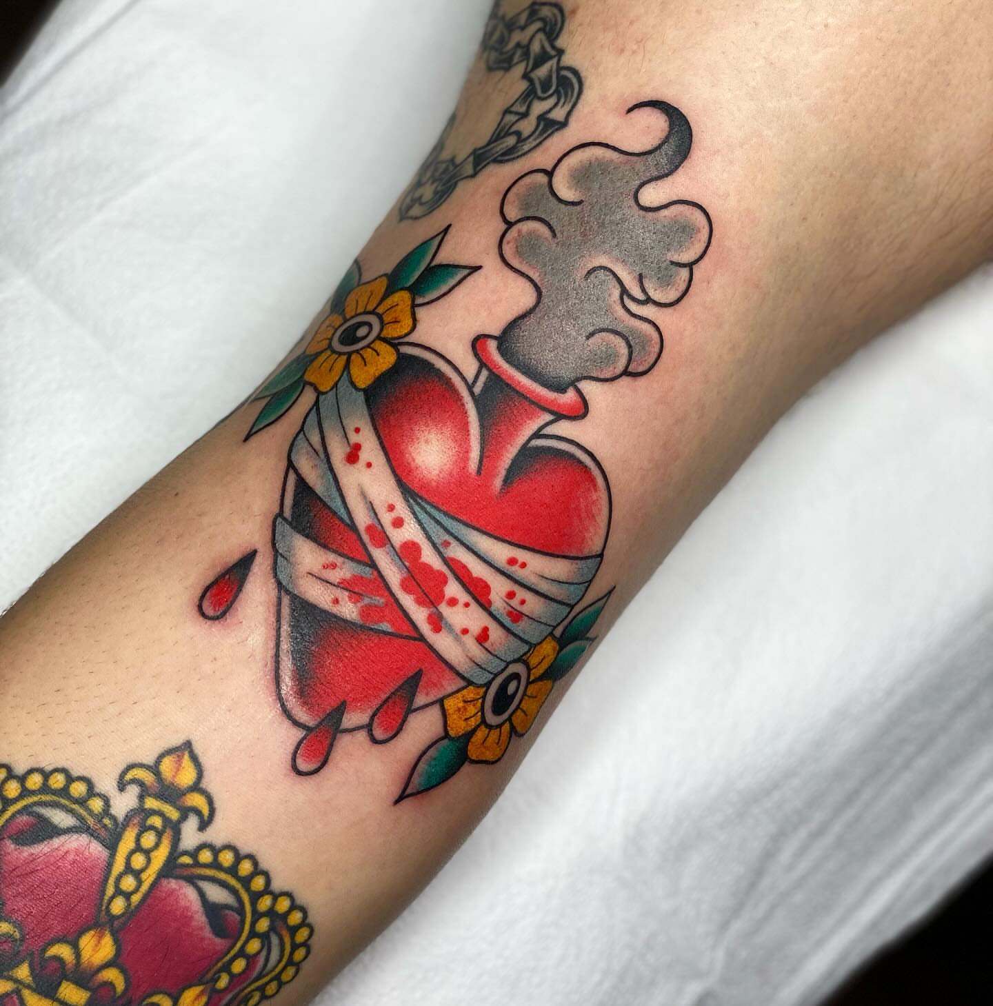 Bandaged heart American traditional tattoo on the forearm by Chelstine, Encinitas, California