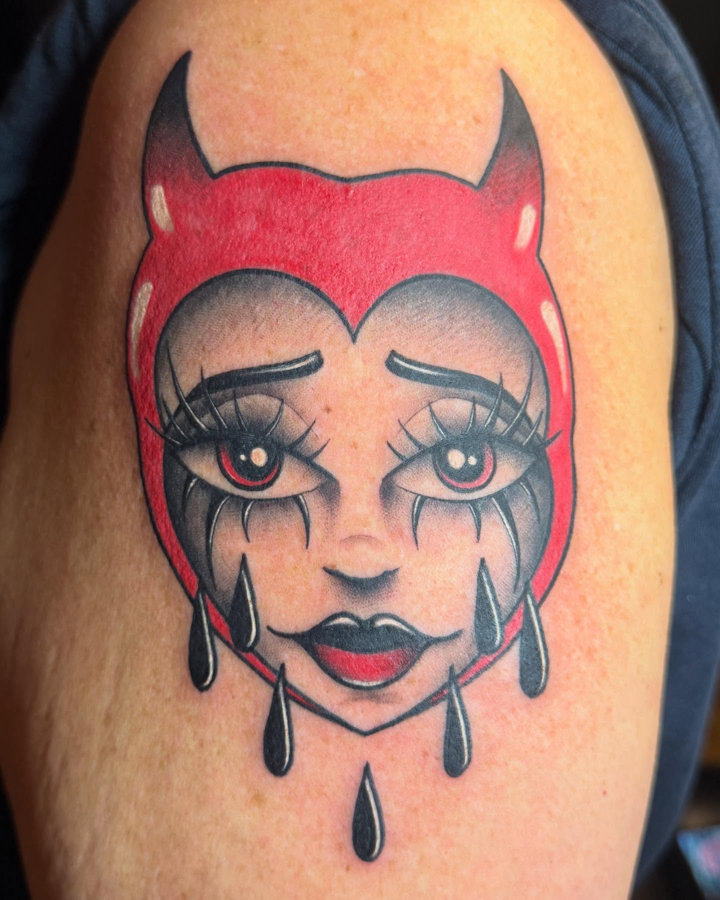 Demon face American traditional tattoo on the shoulder by Shelby Raia