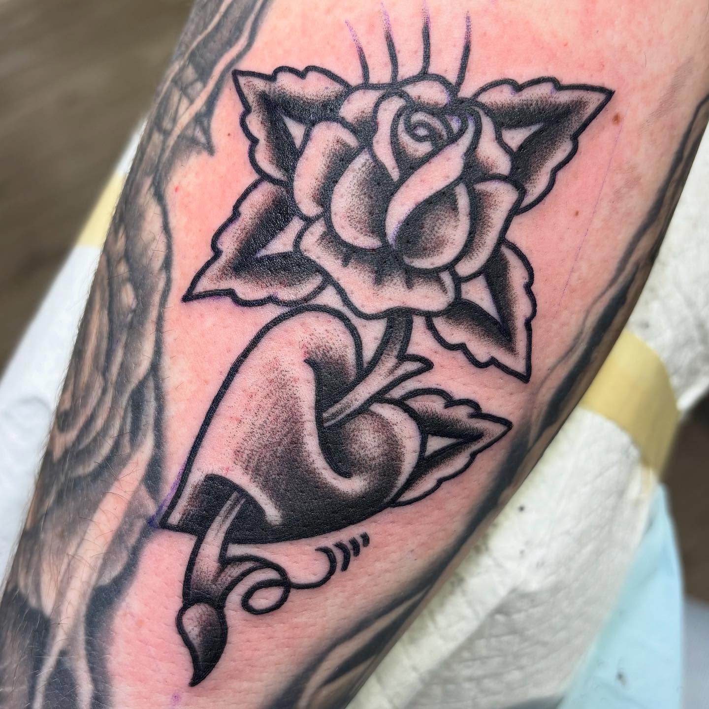 Rose American traditional tattoo on the forearm by Amy Kolton