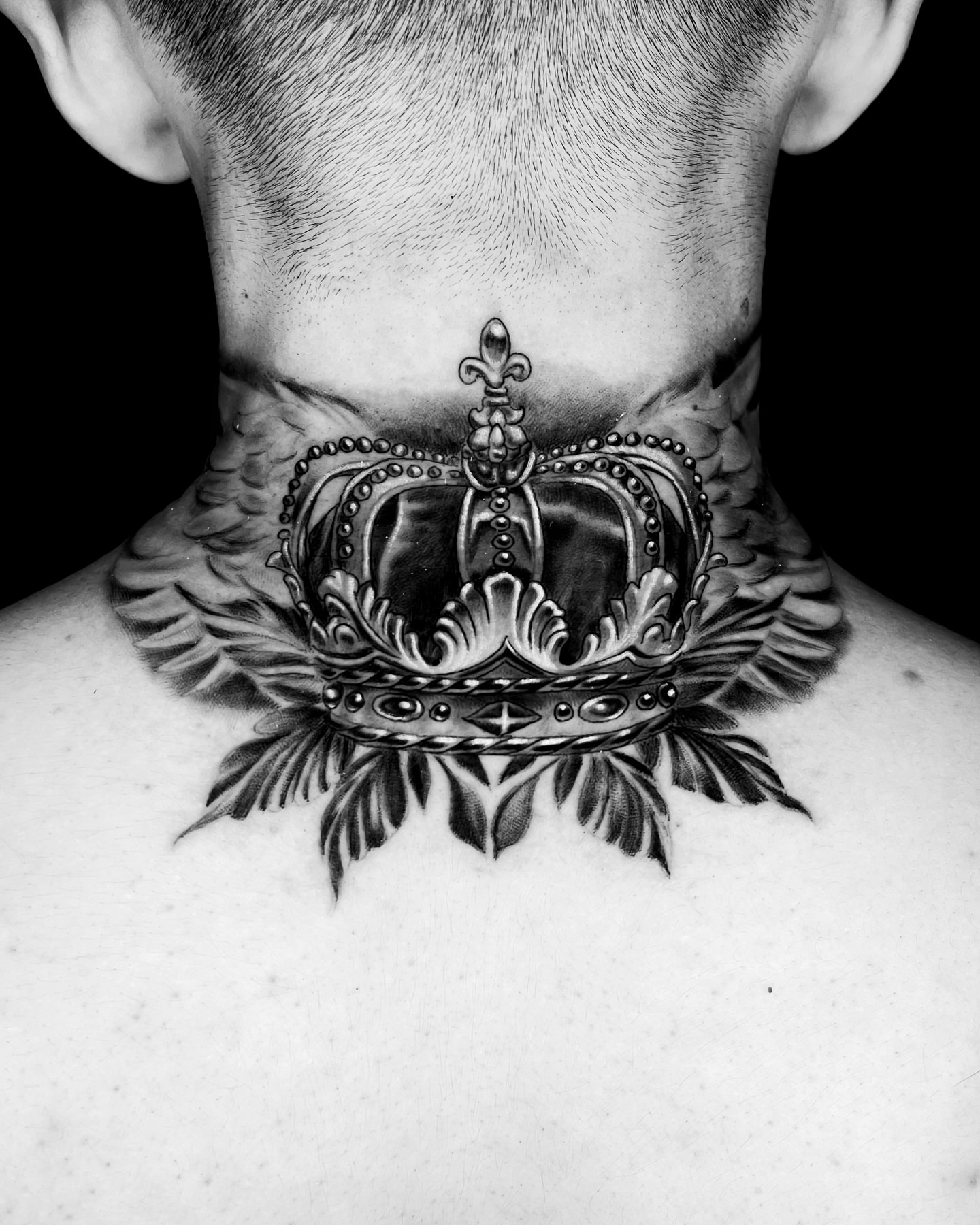 Crown black and grey tattoo on the neck by Tattoo Artist