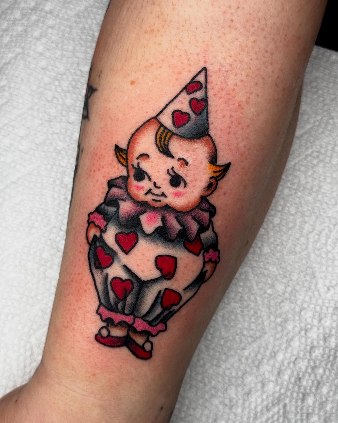 Clown American traditional tattoo on the forearm by Meg Nefcy, Milford, Michigan