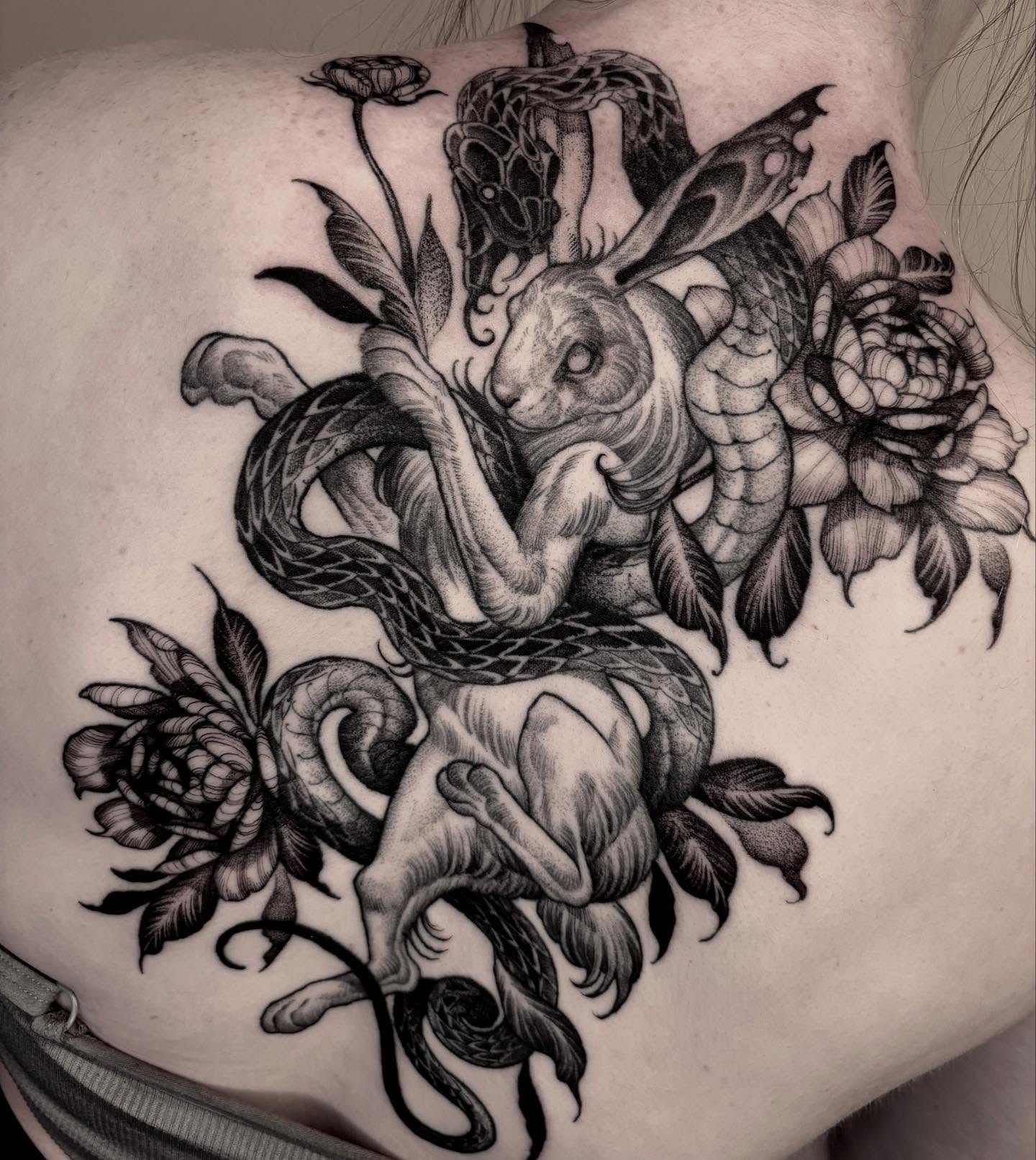 Snake and rabbit realism tattoo on the shoulder by Jens