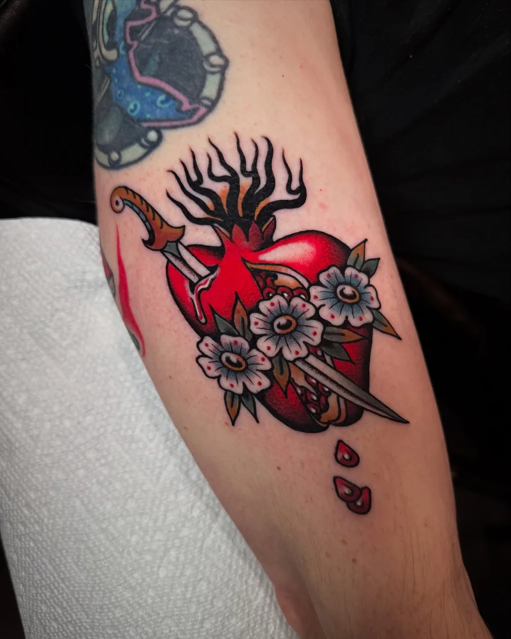 Heart with dagger American traditional tattoo on the forearm by Lauren Vandevier