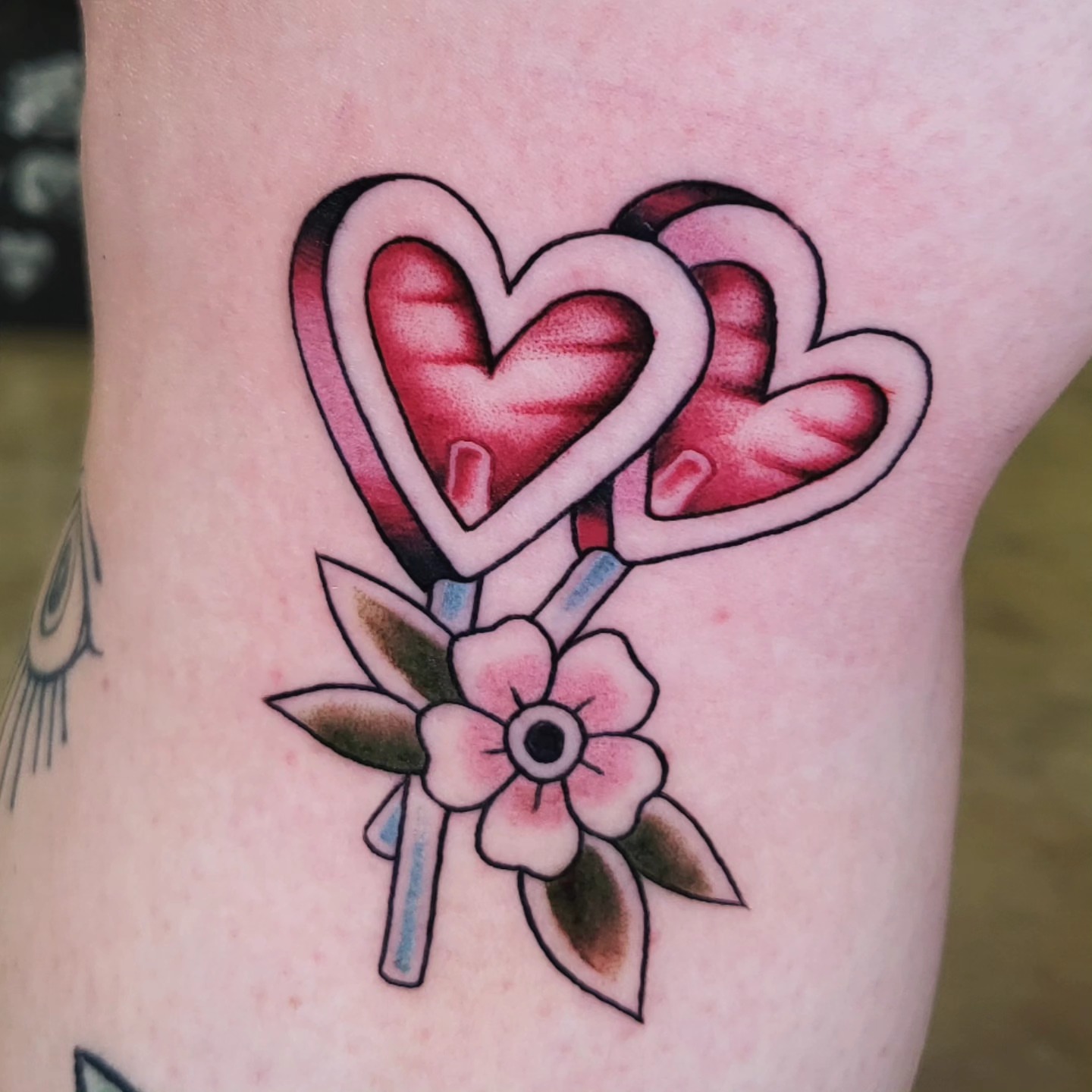 Heart lollipop American traditional tattoo on the forearm by Brenda Juarez - Tattoo Artist