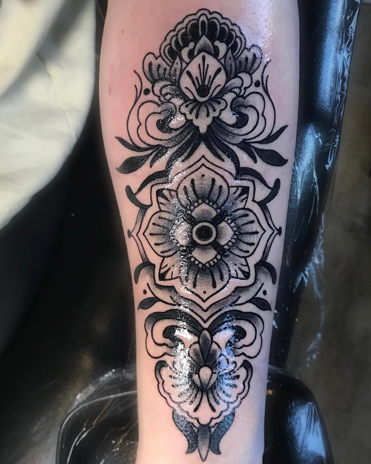 Floral pattern American traditional tattoo on the forearm by Brookelyn