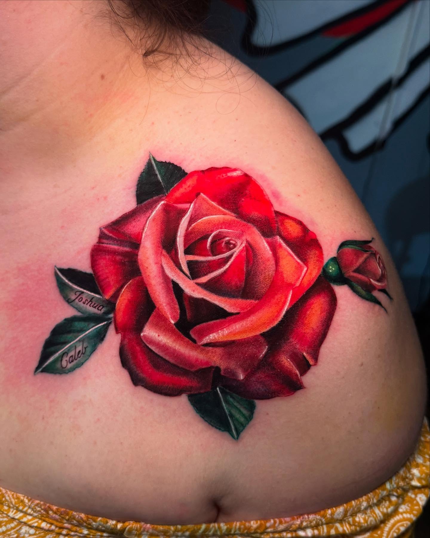 Red rose realism tattoo on the shoulder by Wolf of Wall St.