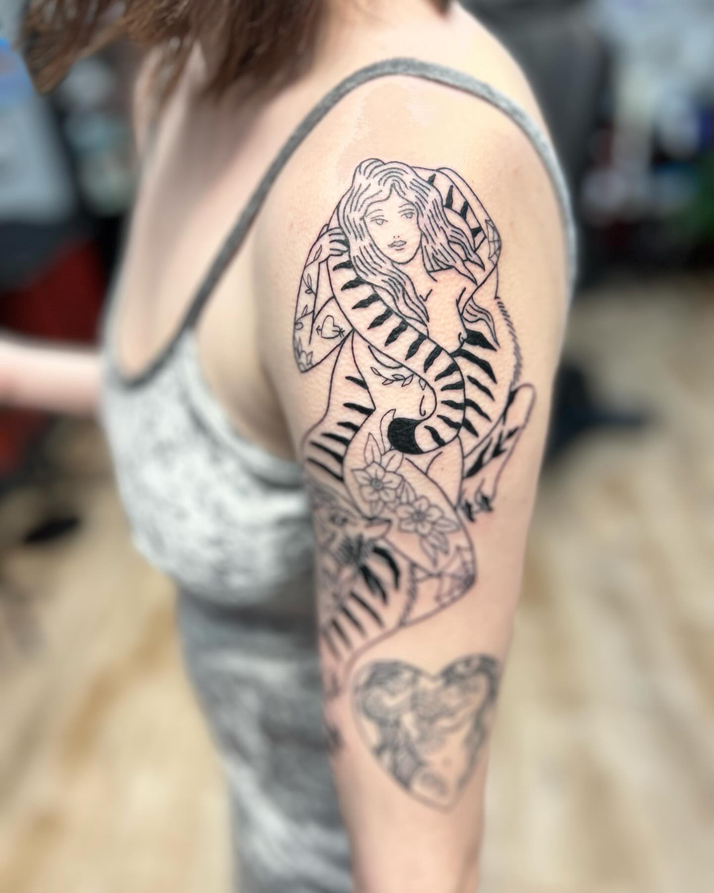 Woman with snake black and grey tattoo on the upper arm by Ricardo (RJ)