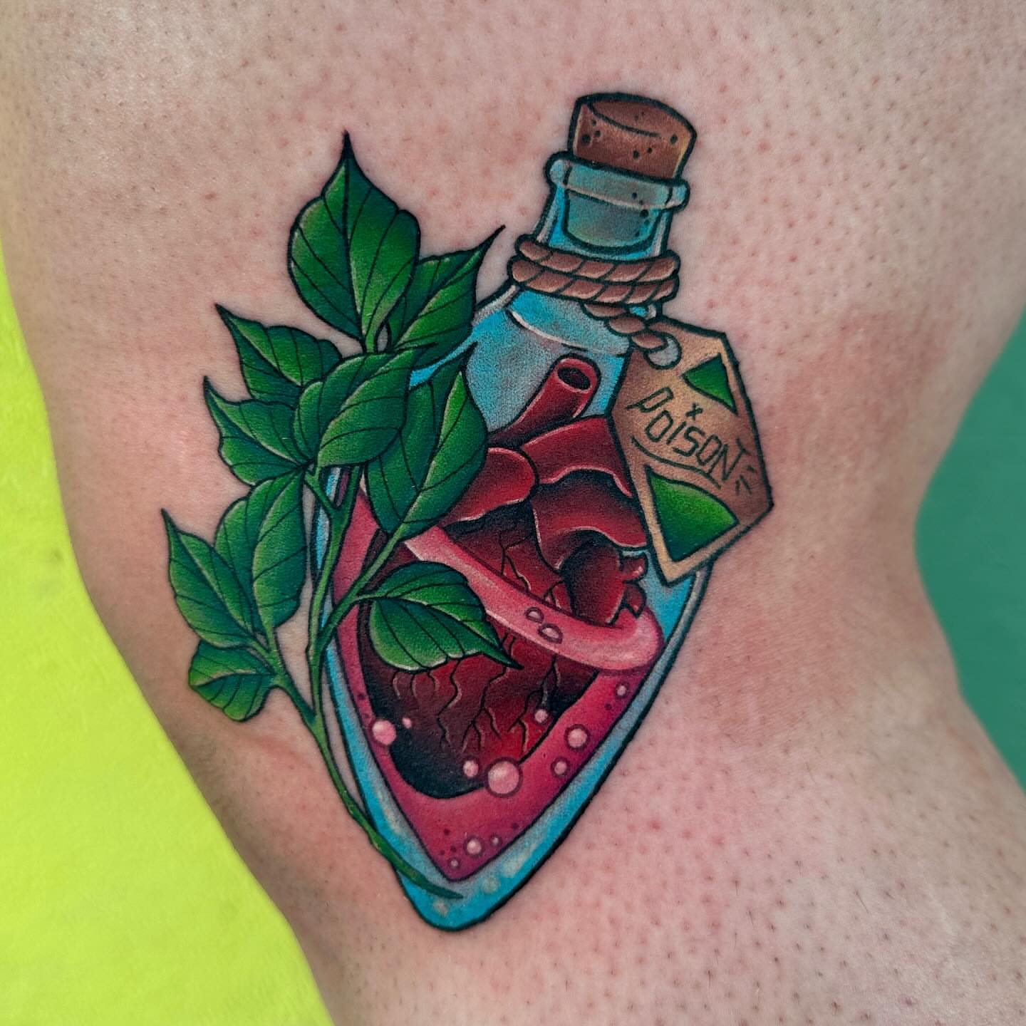 Anatomical heart in bottle realism tattoo on the thigh by Holle Hellfire