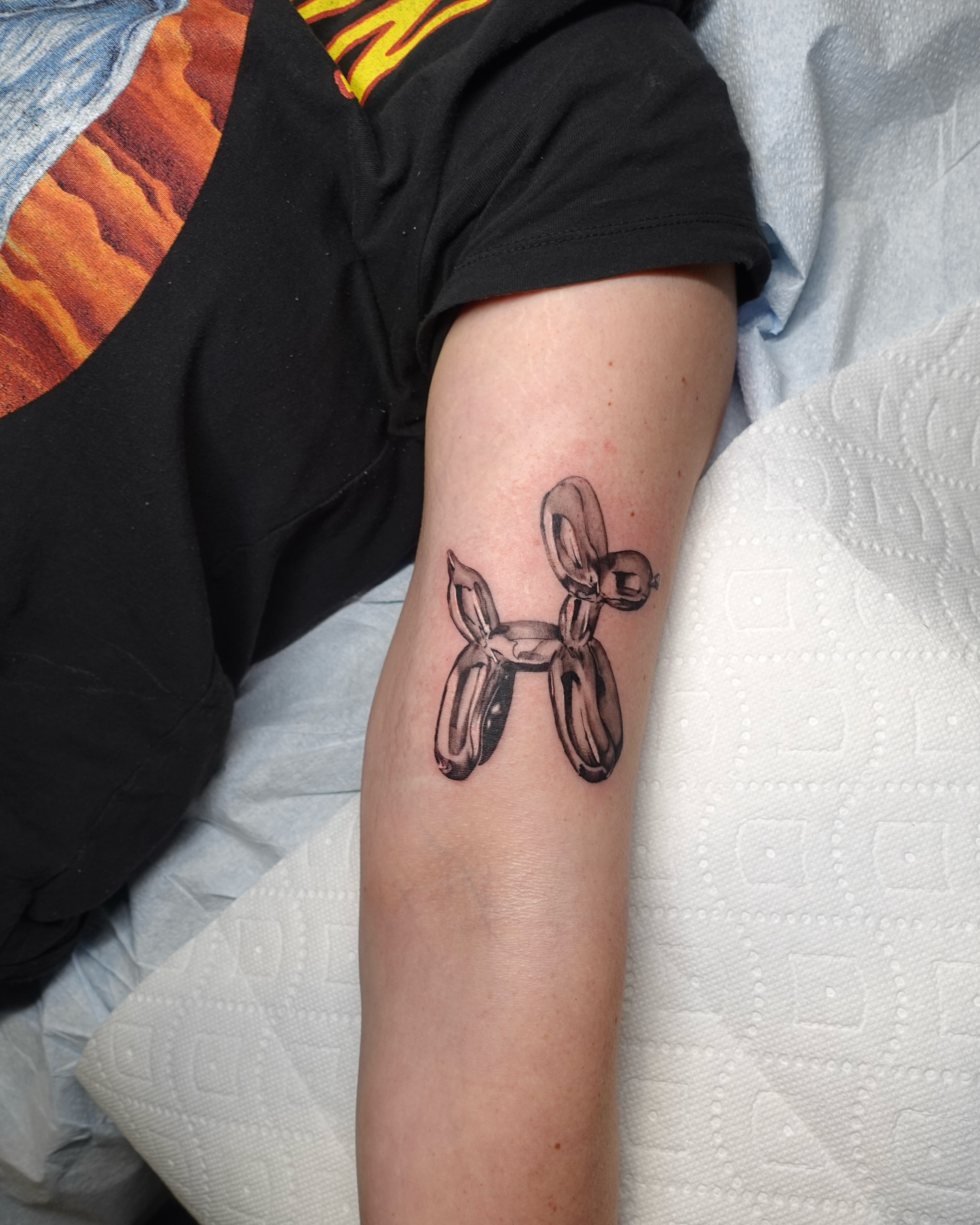 Balloon animal black and grey tattoo on the forearm by Tat by Brendan