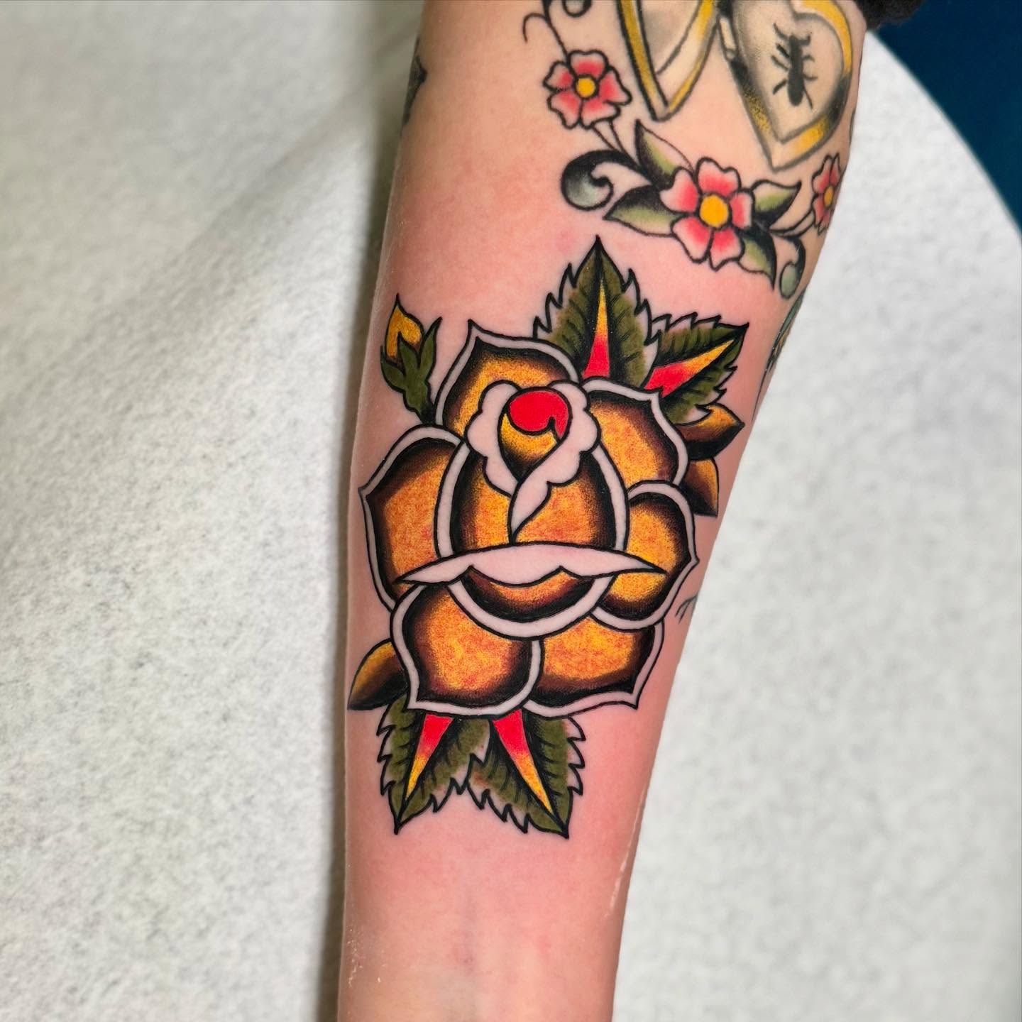 Rose American traditional tattoo on the forearm by 🌸Elena Scott🌵Ohio Tattoo Artist