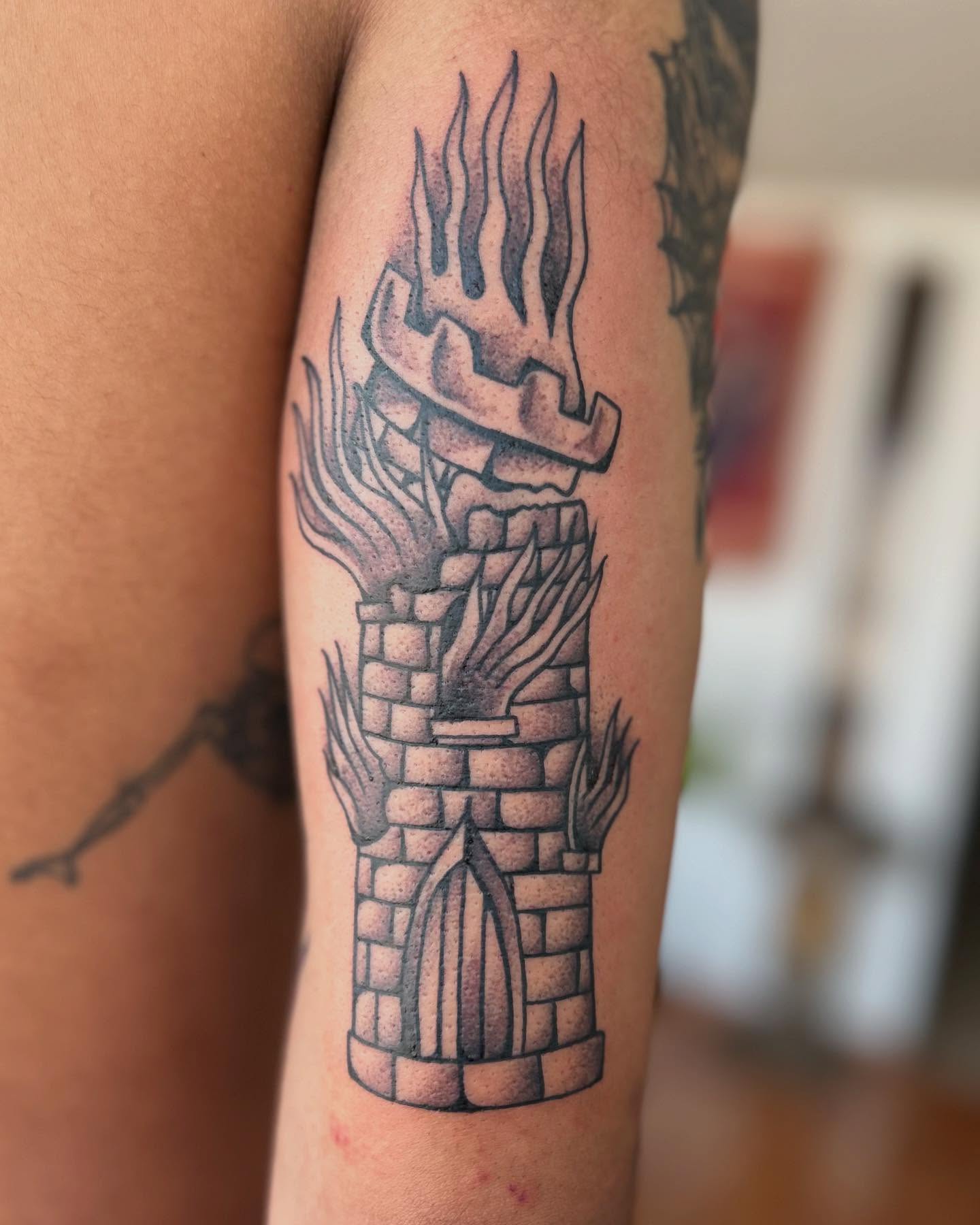 Fire-breathing dragon black and grey tattoo on the forearm by Barro