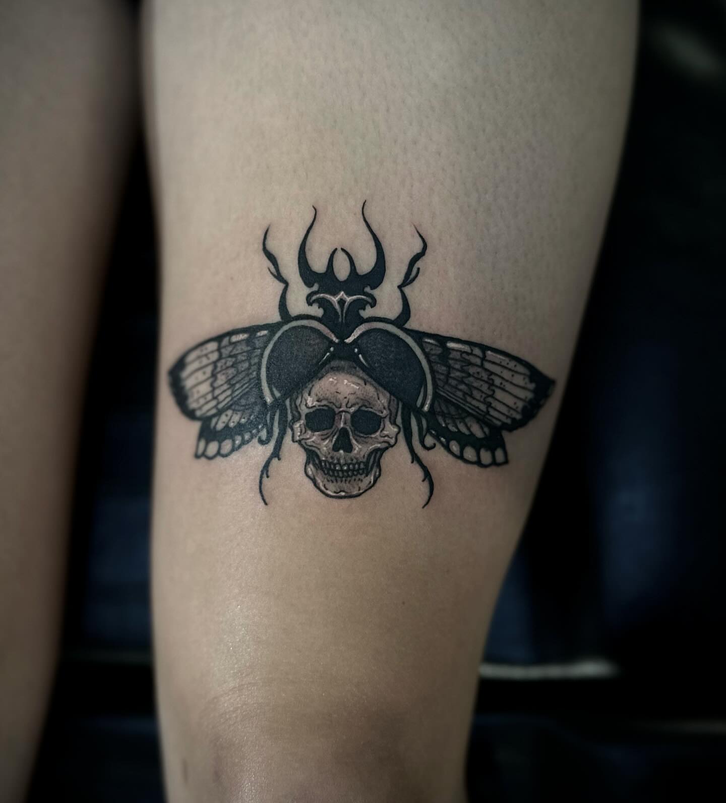 Skull with wings black and grey tattoo on the forearm by 𝕽𝖎𝖌𝖊𝖗𝖘 𝕳𝖆𝖒𝖟𝖆, San Francisco, California