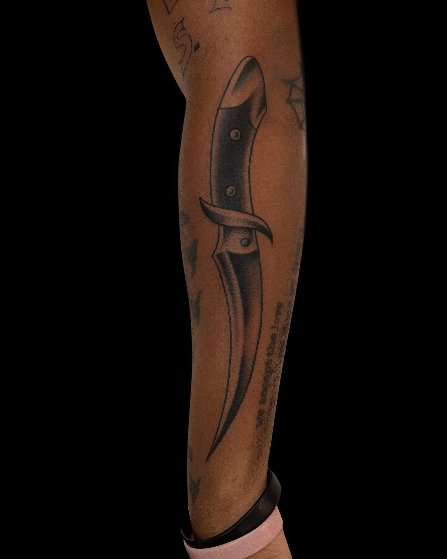 Knife black and grey tattoo on the forearm by Jason