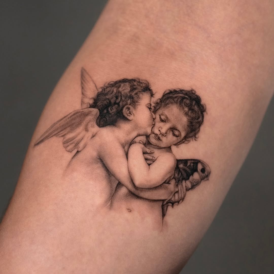Two cherubs with a moth realism tattoo on the forearm by Valery Cardona