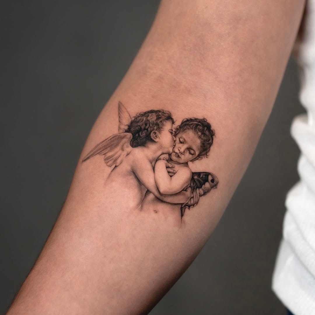 Two cherubs with a moth realism tattoo on the forearm by Valery Cardona