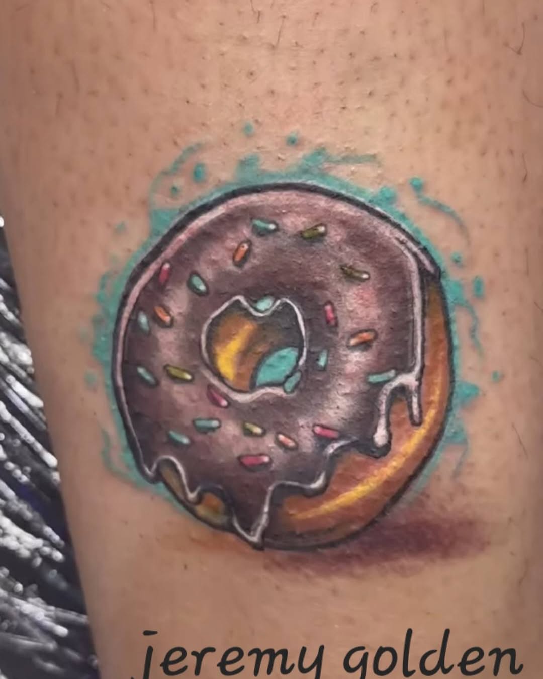 Donut new school tattoo on the forearm by Germaine Sherman