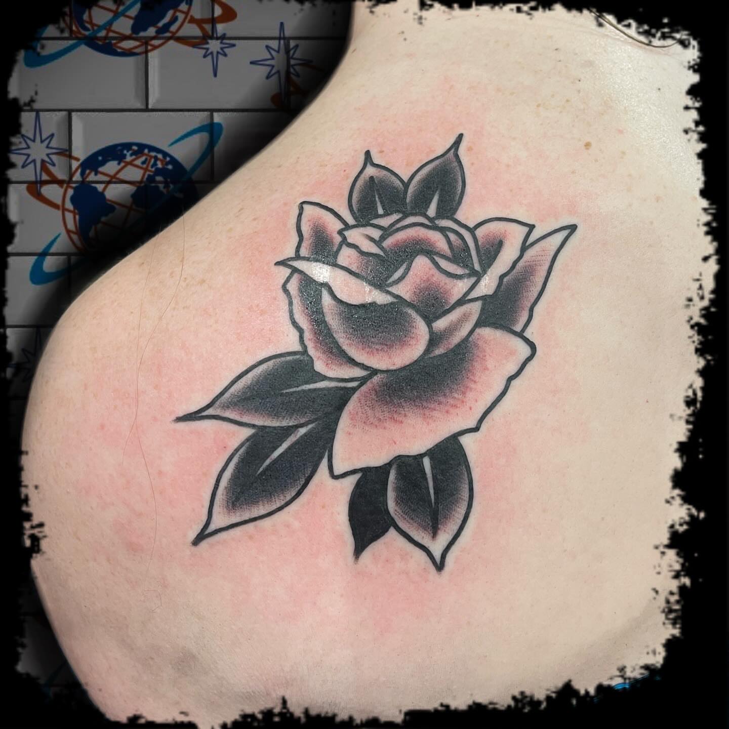Rose black and grey tattoo on the shoulder by Antonio DeCaro