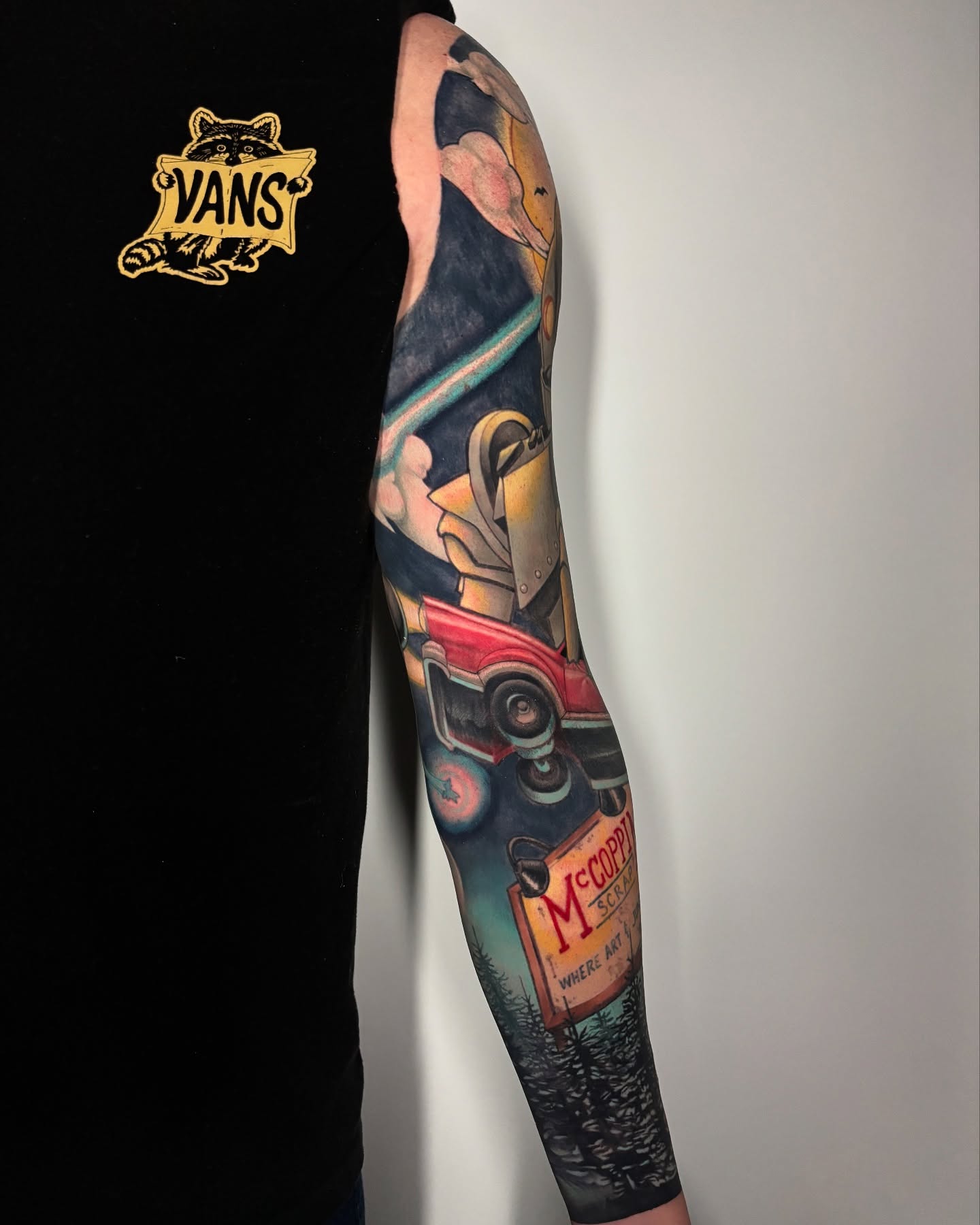 Car and sign realism tattoo on the forearm by Jon Ronzka