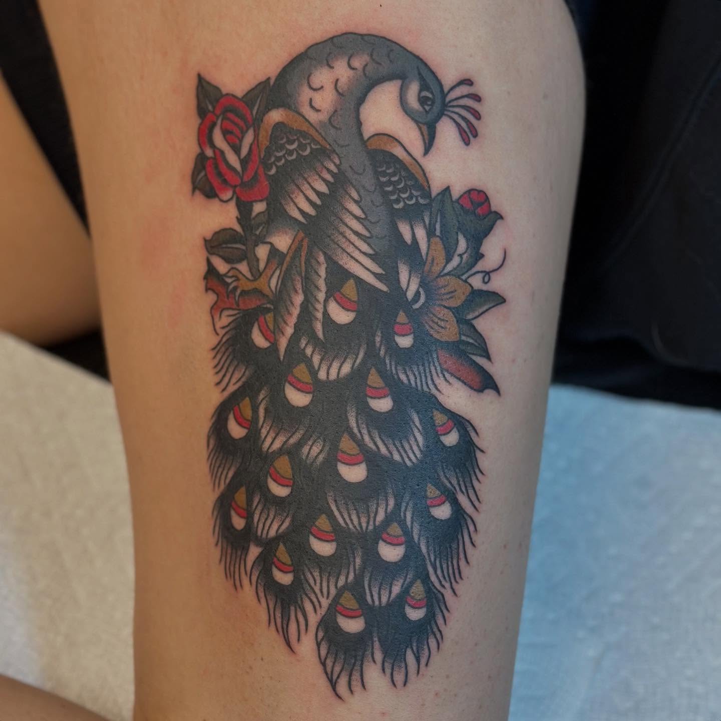 Peacock American traditional tattoo on the thigh by @ryleecoyote, New York, New York