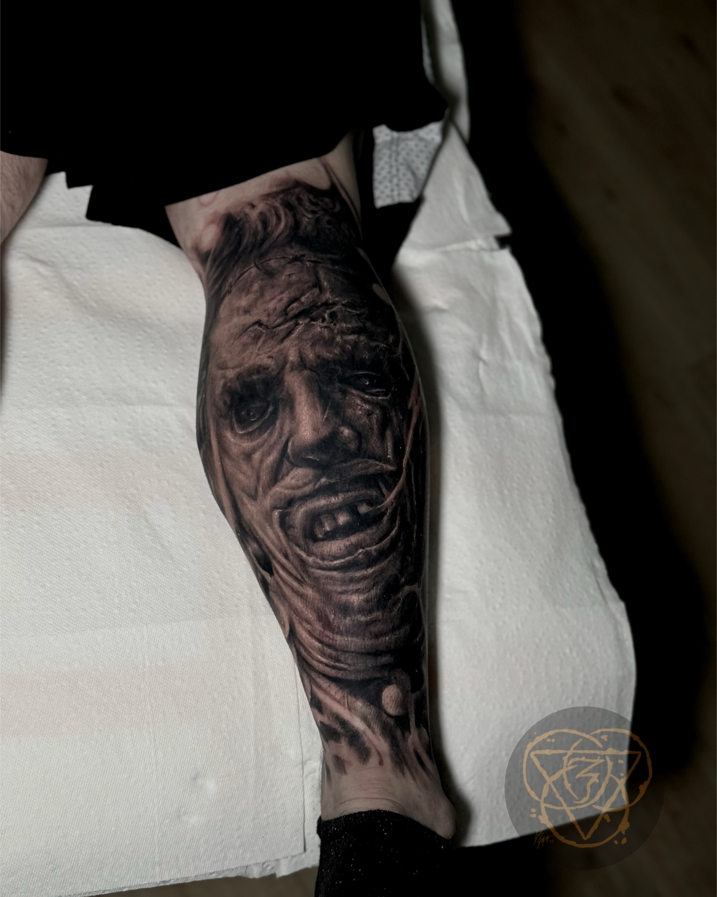Grimacing face realism tattoo on the forearm by Justin (iam3) Leifeste