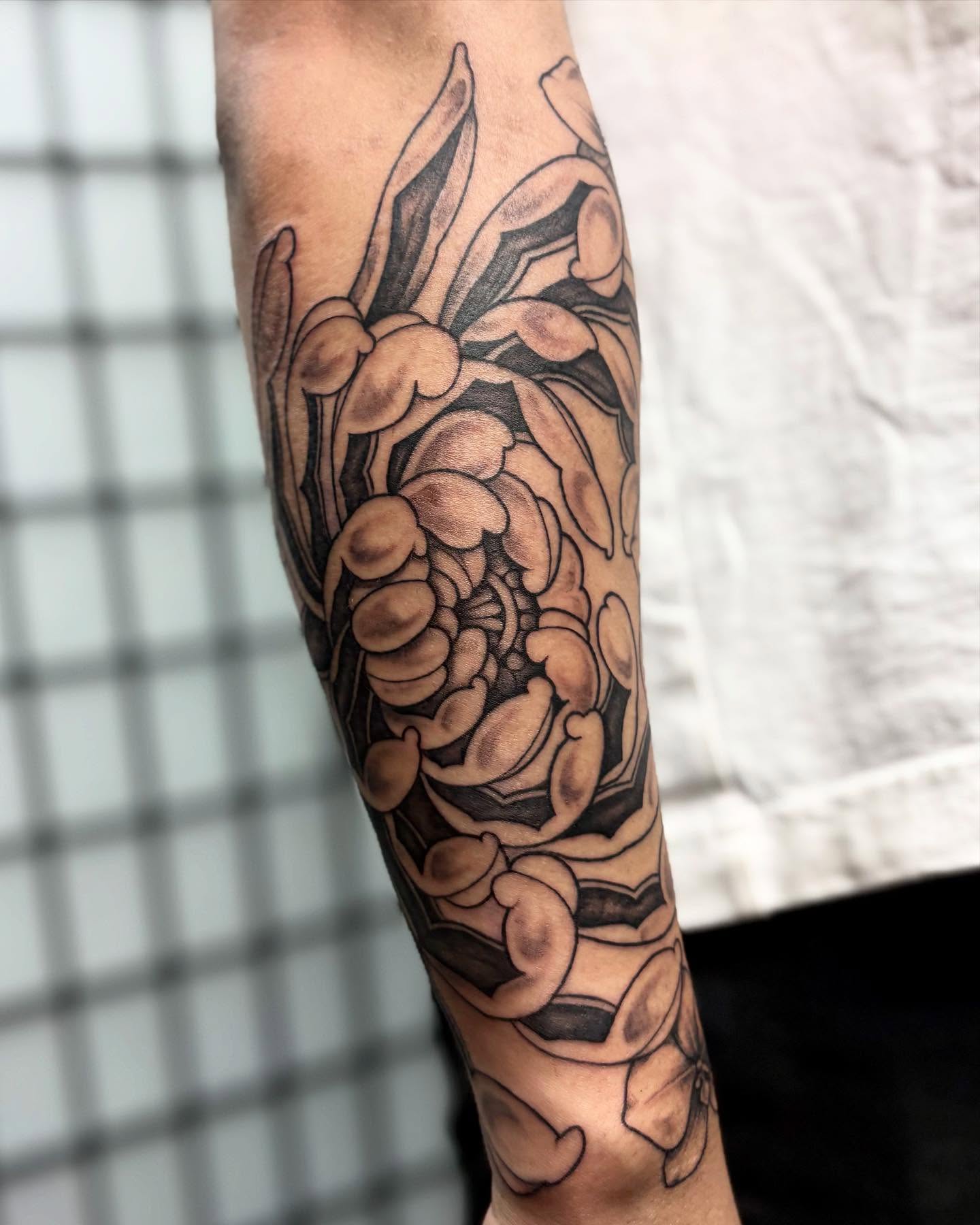 Chrysanthemum black and grey tattoo on the forearm by Tattoos by Tessa
