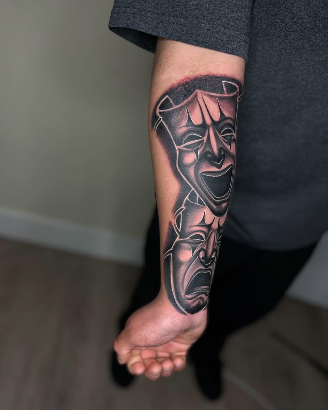 Comedy and tragedy masks realism tattoo on the forearm by Tattoo Artist