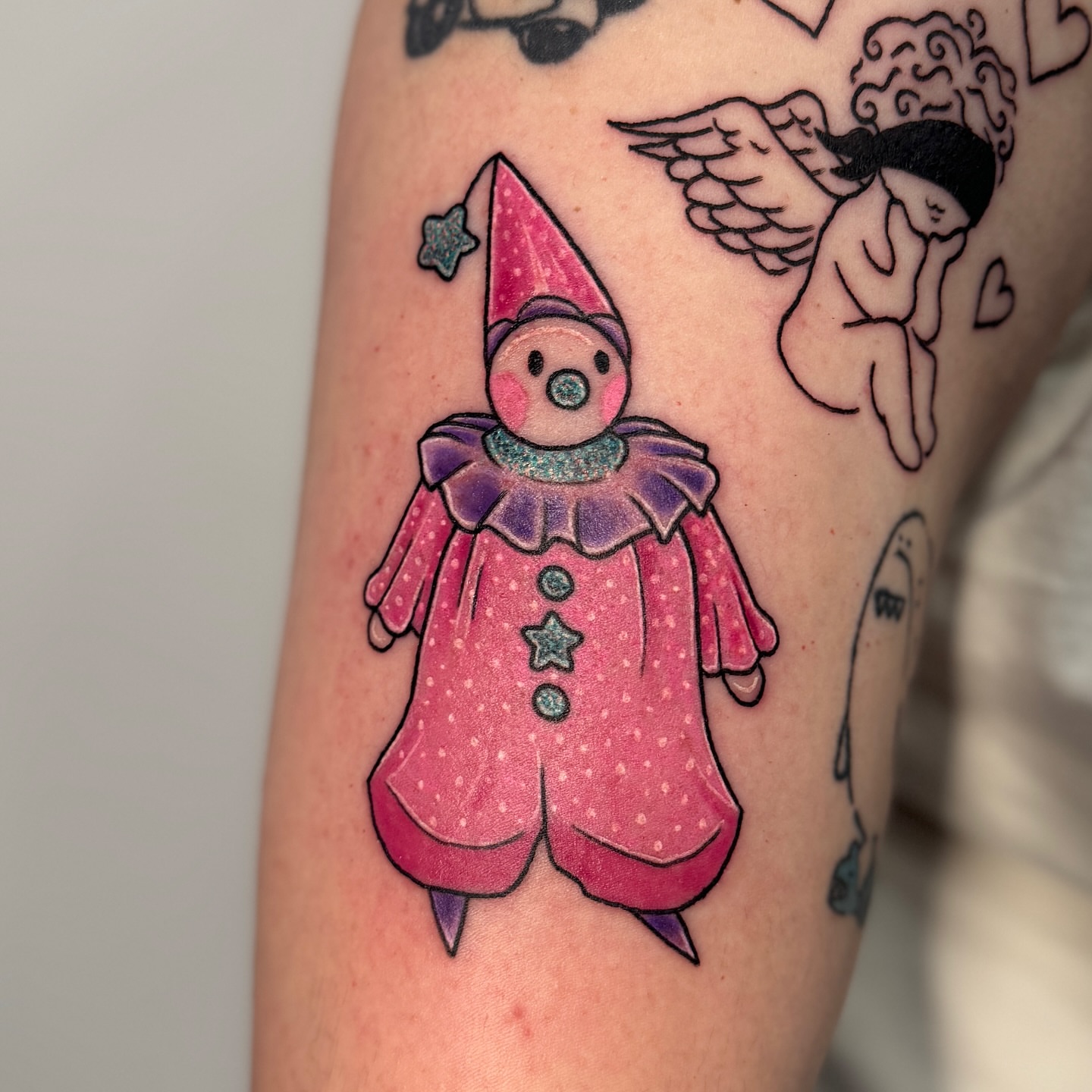 Clown trash polka tattoo on the forearm by Ashley Rose - Minnesota Tattoo Artist