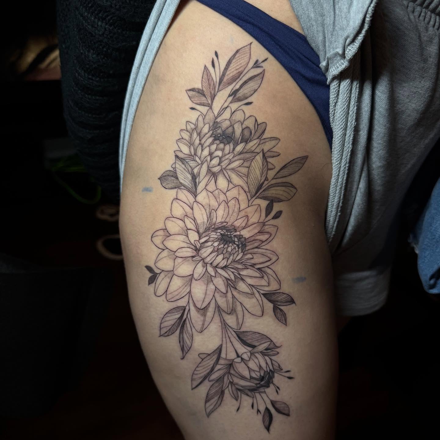 Chrysanthemums black and grey tattoo on the thigh by Elian Sanchez Austin Tx. Tattoo Artist
