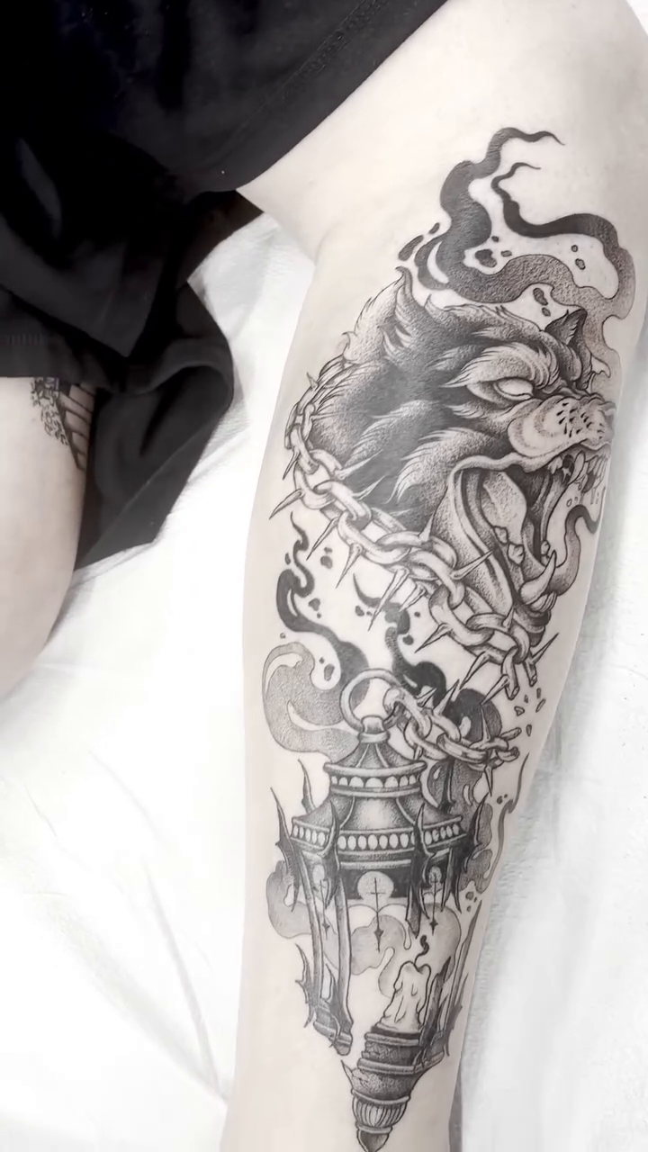 Wolf and lantern realism tattoo on the forearm by Zoe D