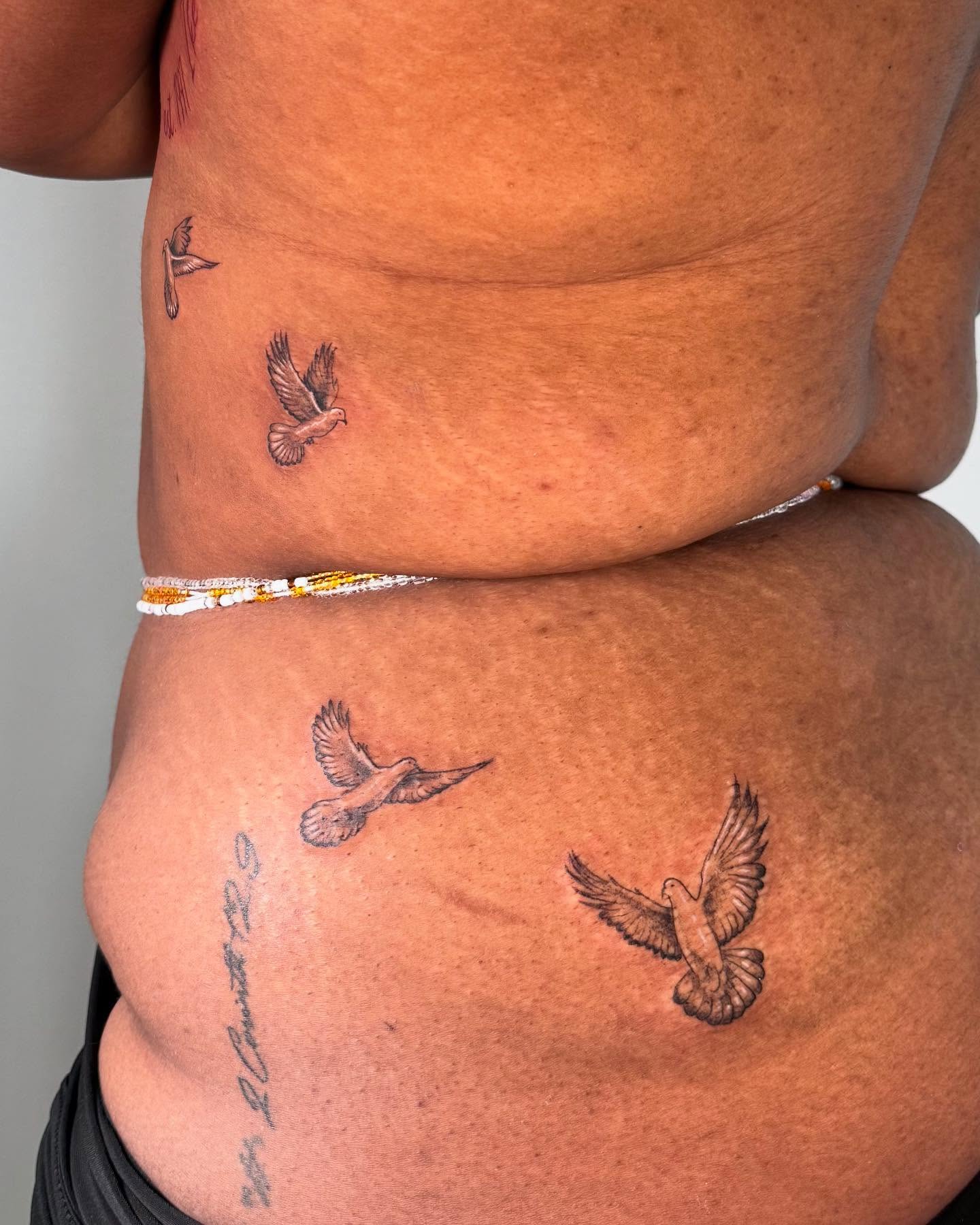 Birds black and grey tattoo on the torso by Diana
