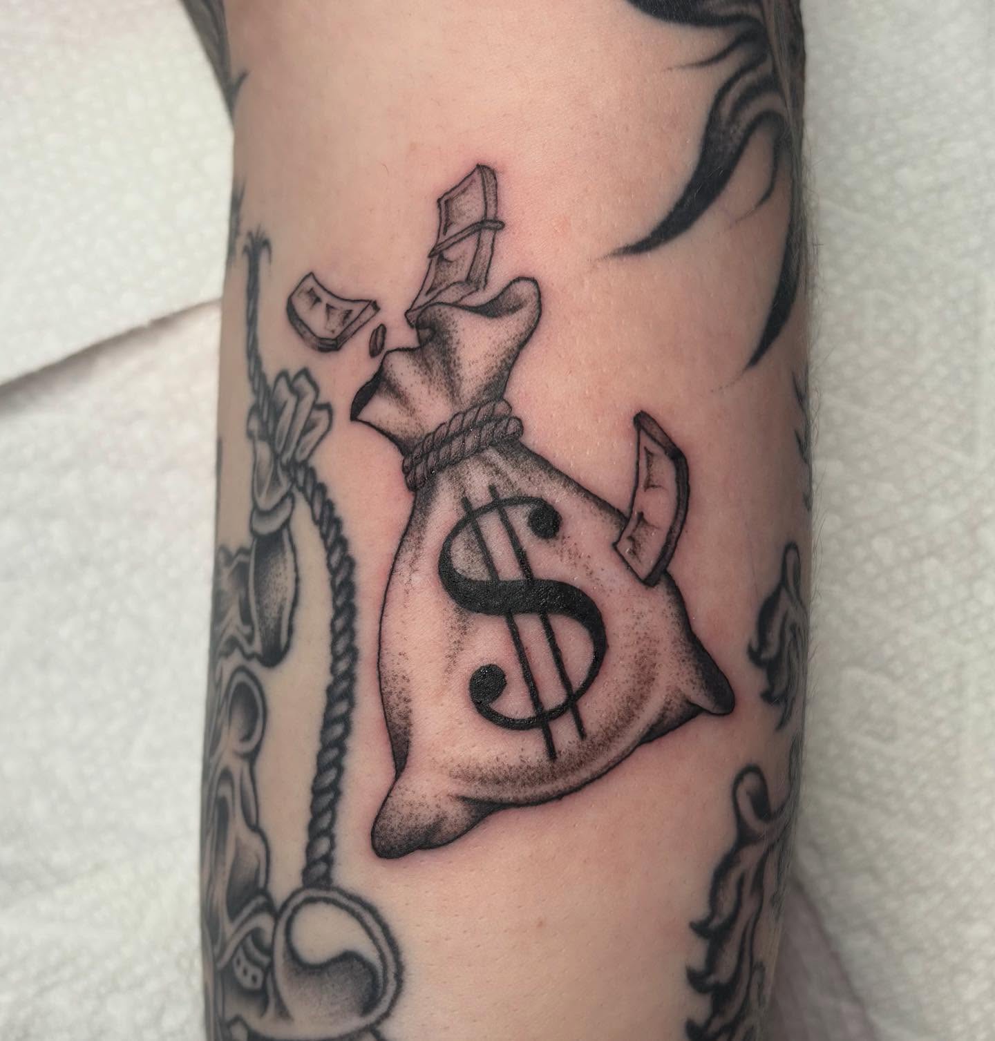 Money bag with top hat American traditional tattoo on the forearm by ⟡ Sam O ⟡
