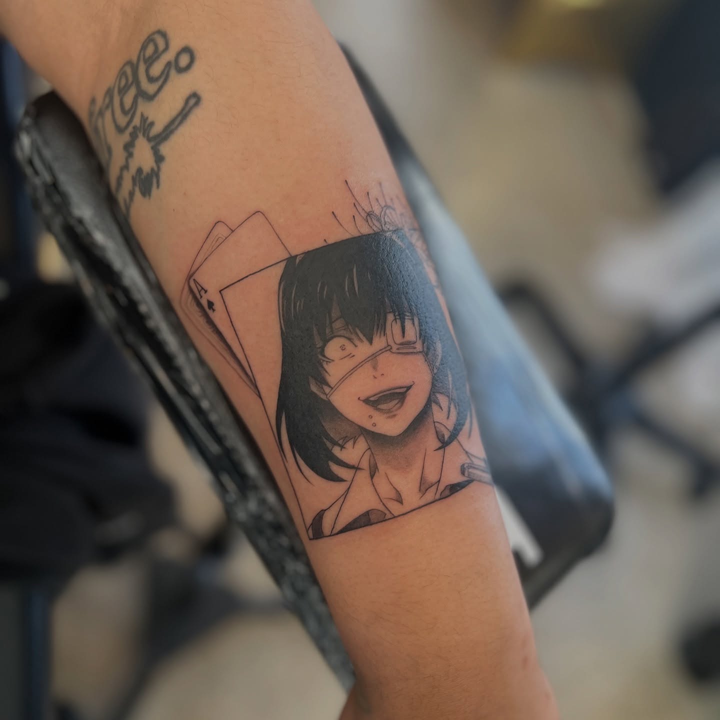 Anime character black and grey tattoo on the forearm by Dom