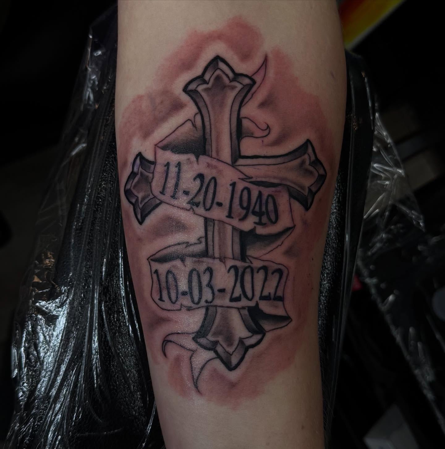 Cross with banners black and grey tattoo on the forearm by Lu Ve, Dayton, Ohio