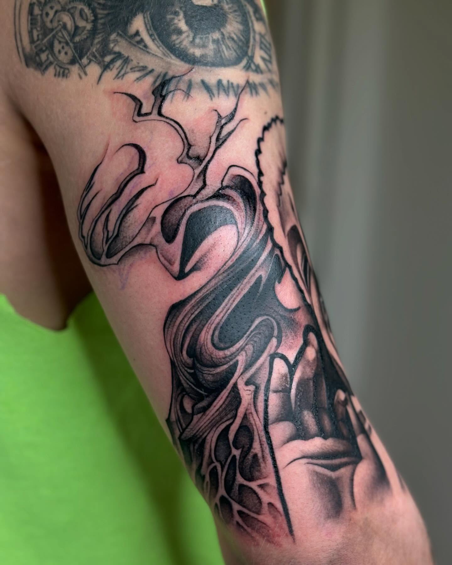 Abstract biomechanical realism tattoo on the forearm by orlando
