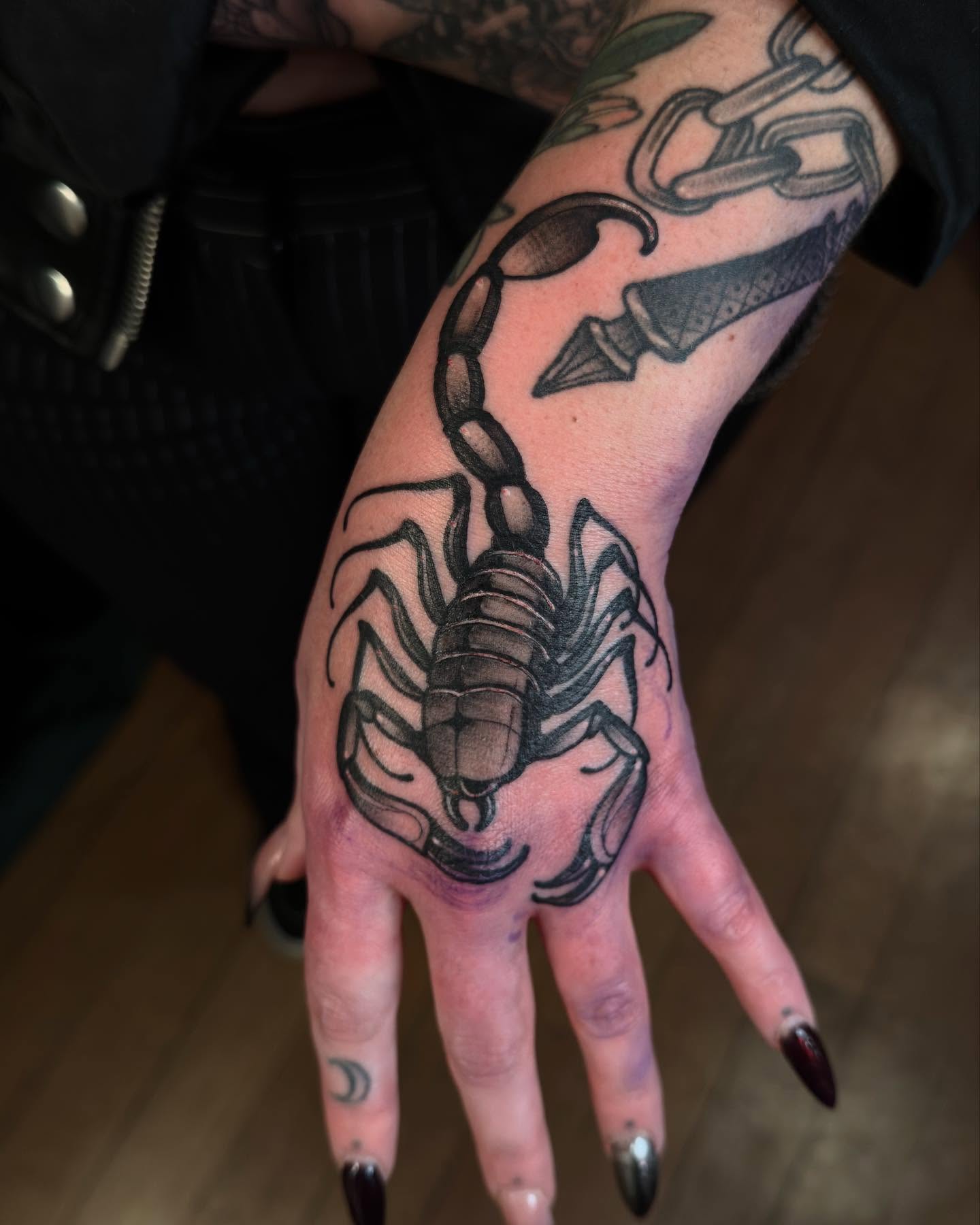 Scorpion black and grey tattoo on the hand by Jessica Haug