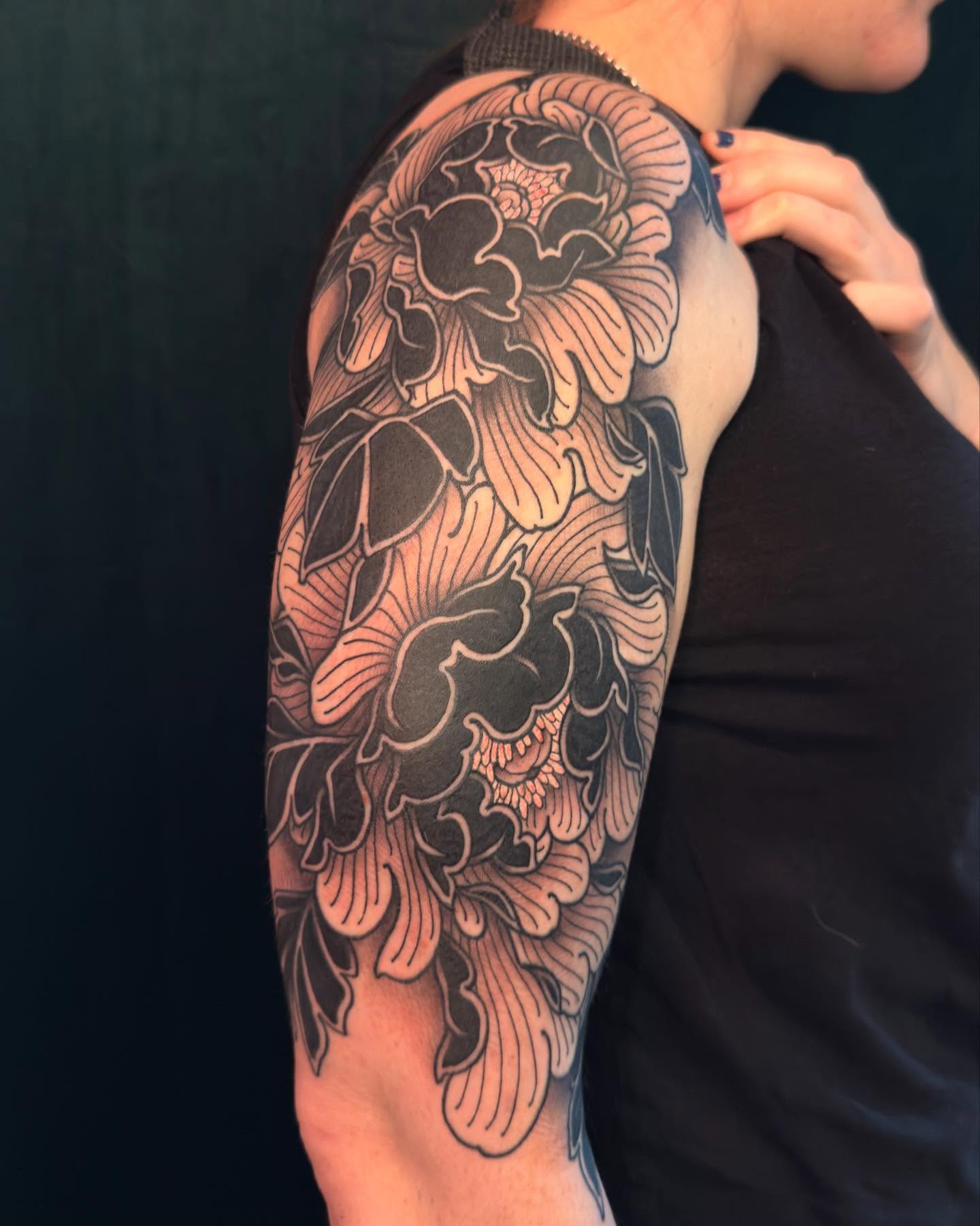 Peony flowers japanese irezumi tattoo on the upper arm by Jessica Haug