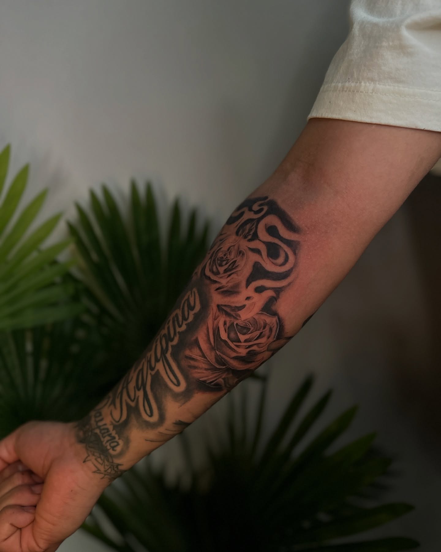 Rose and snake realism tattoo on the forearm by ᴡᴏʀᴍ