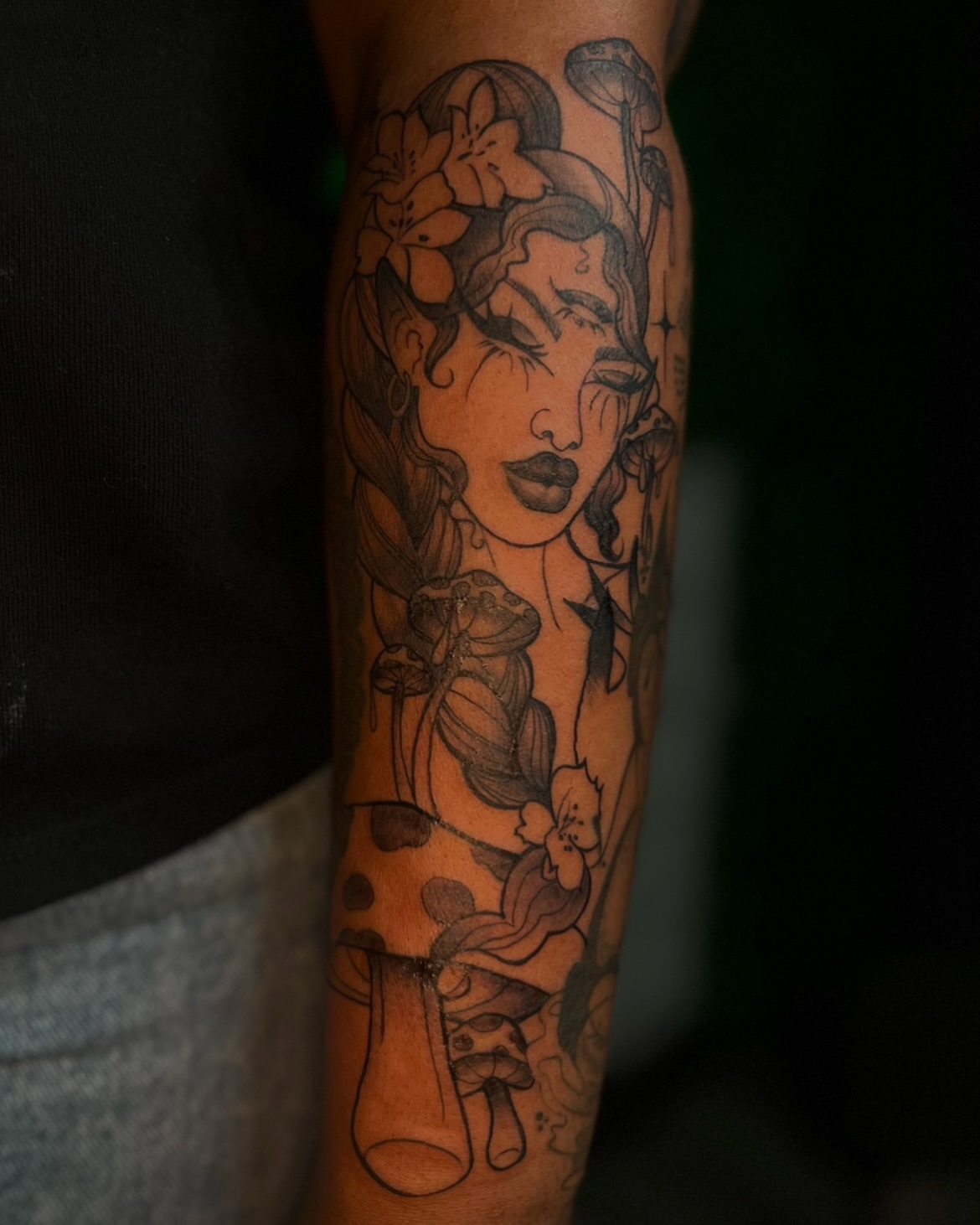 Woman with flowers realism tattoo on the forearm by Los Angeles Tattoo Artist