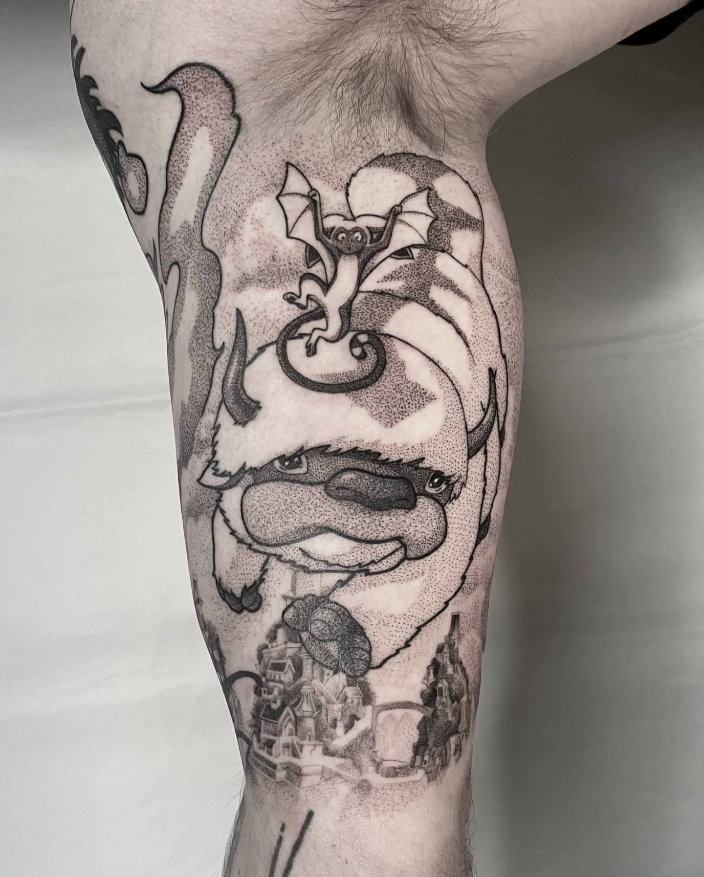 Dragon and cityscape dotwork tattoo on the leg by Rowan Starr
