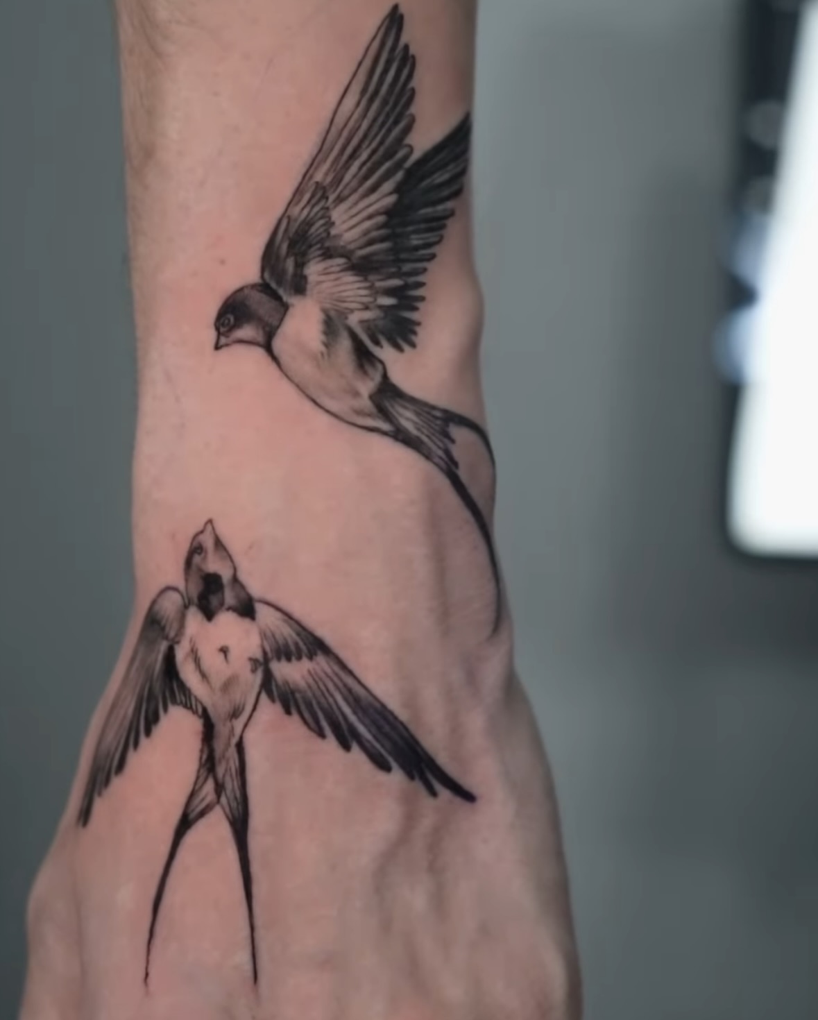 Swallows black and grey tattoo on the forearm by Diego Andrés Cárdenas