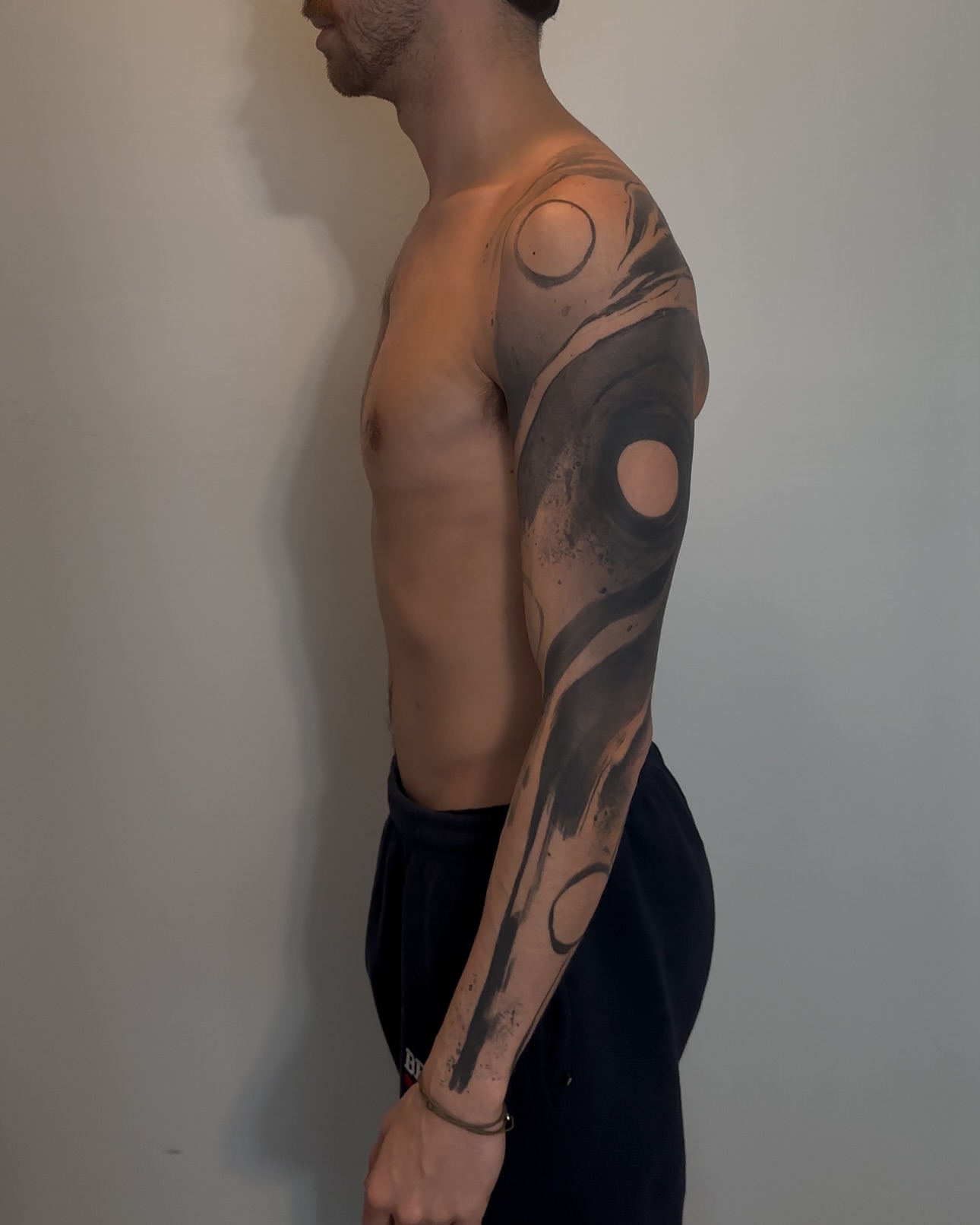 Abstract swirls geometric tattoo on the upper arm by Rizzie D'Alterio