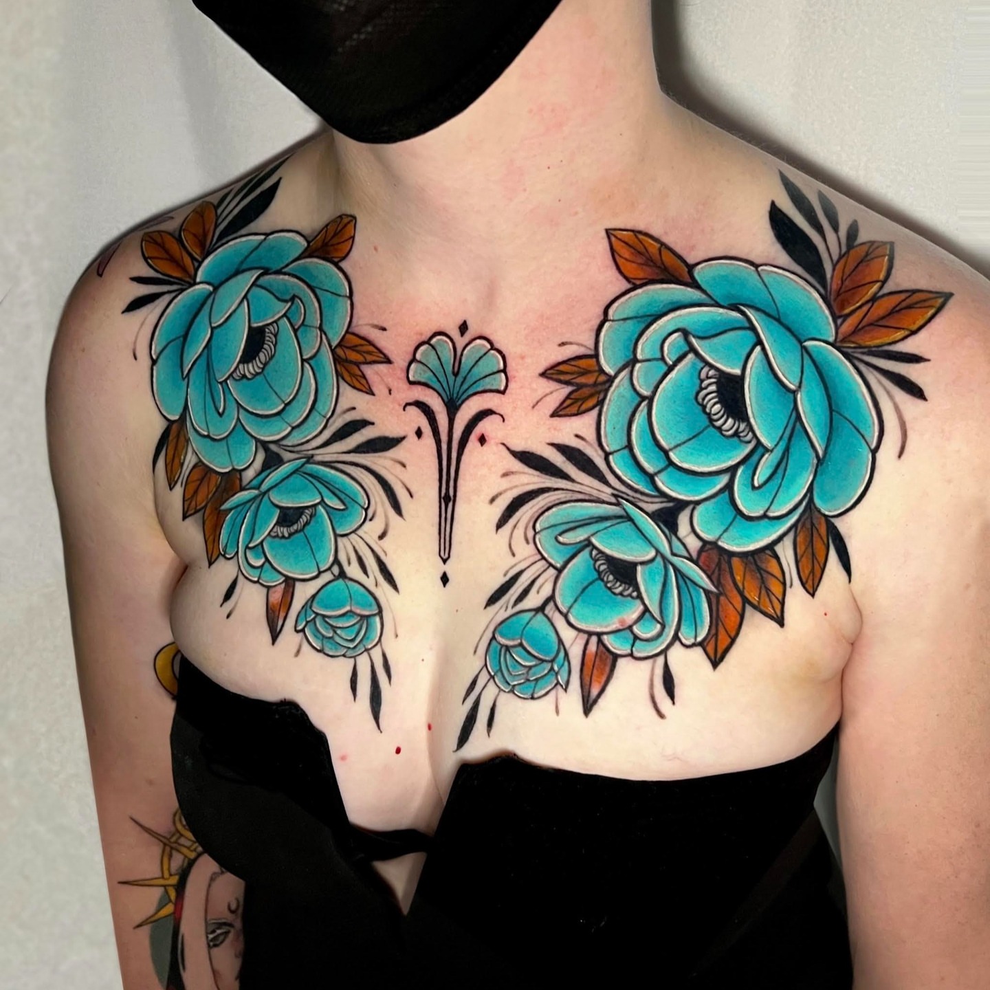 Floral bouquet American traditional tattoo on the chest by Cortney Norton
