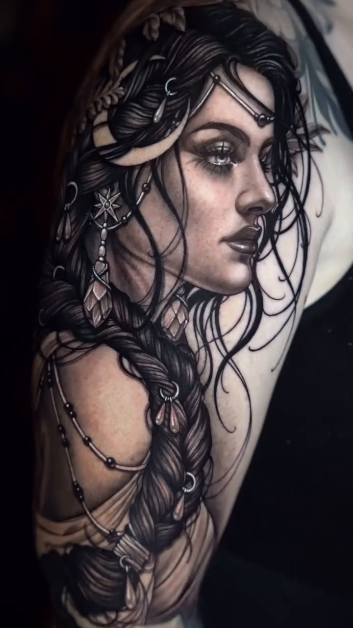Woman with braided hair realism tattoo by Nikki Simpson