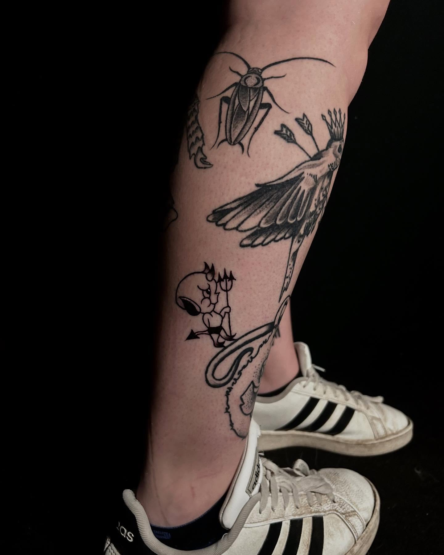 Insect and bird black and grey tattoo on the calf by Alex Richardson