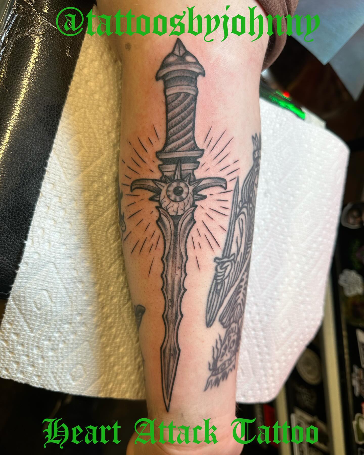 Sword black and grey tattoo on the forearm by Johnny Sepulveda