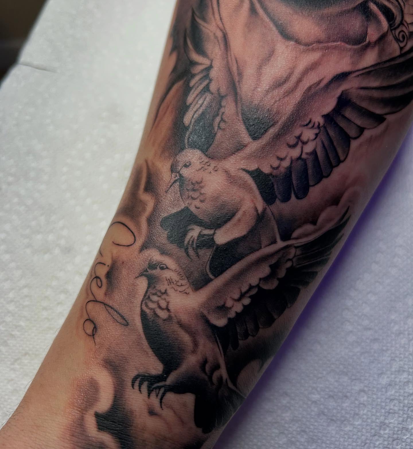 Doves realism tattoo on the forearm by Denis Morello de Castro, South River, New Jersey